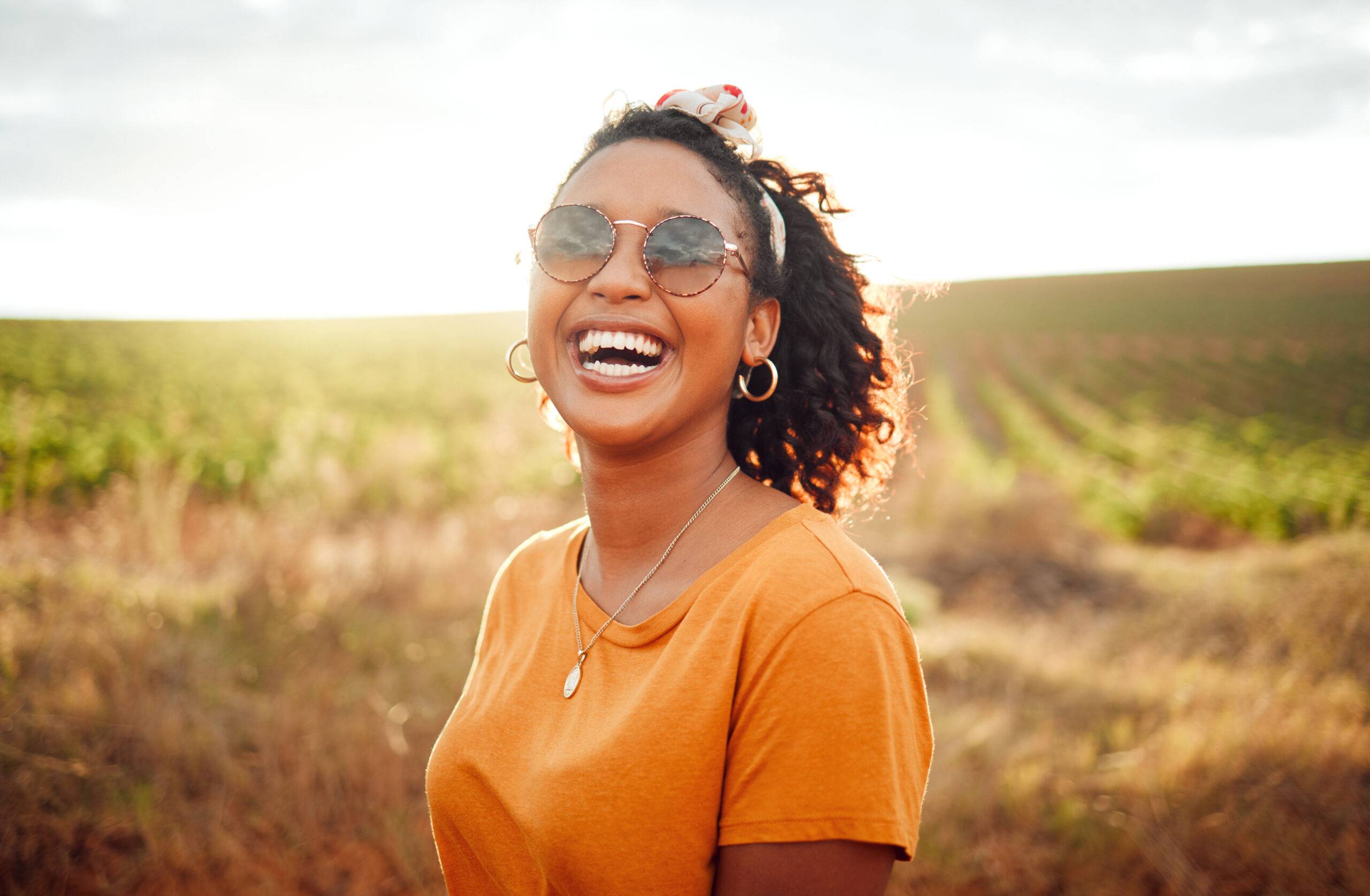 smiling woman standing in a field
