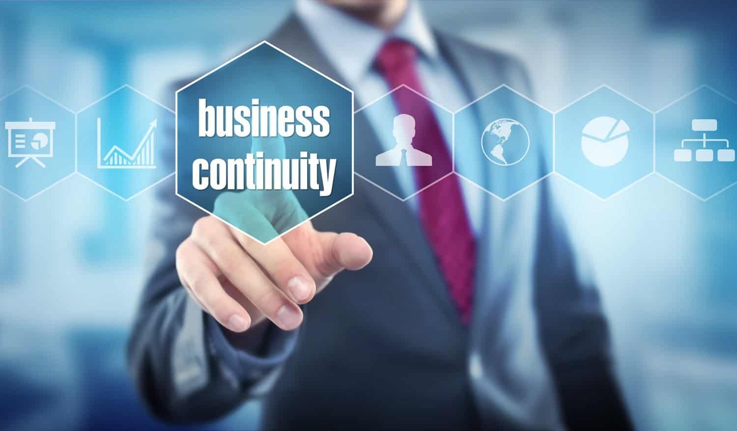 Businessperson pointing to a graphic background that says “business continuity”