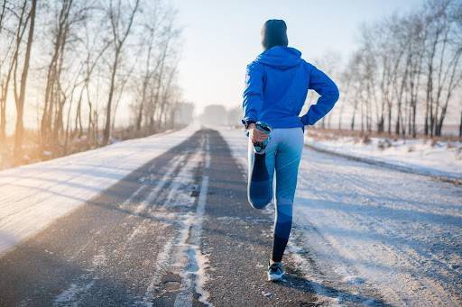 Person stretching outside on a winter run