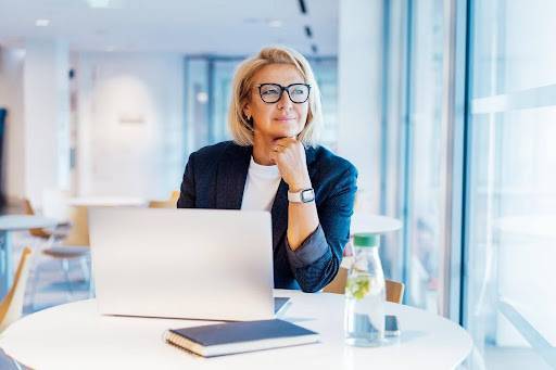 Businesswoman on laptop looking to the side