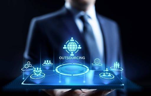 Businessman with outsourcing neon sign