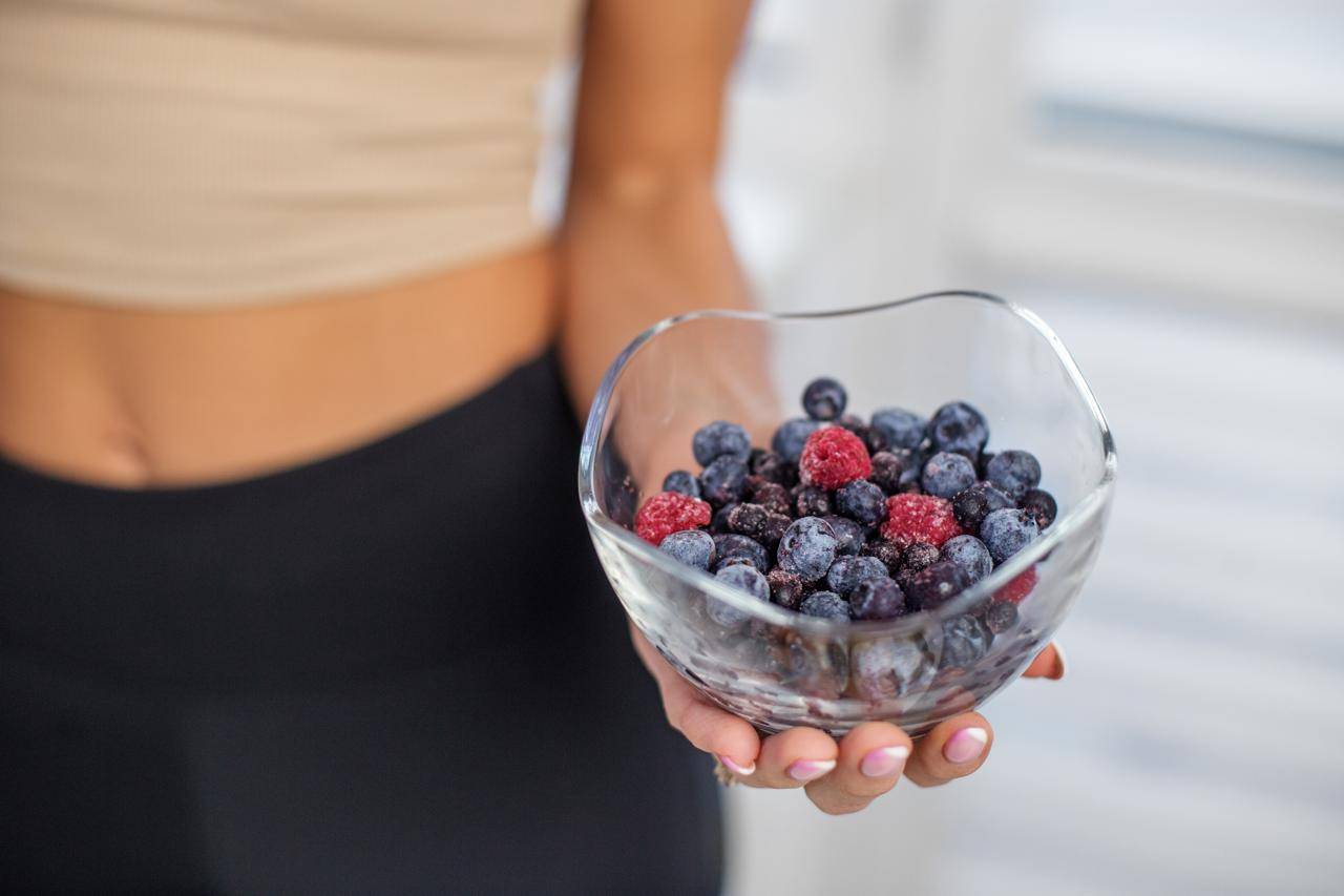 Woman holding a bowl of berries