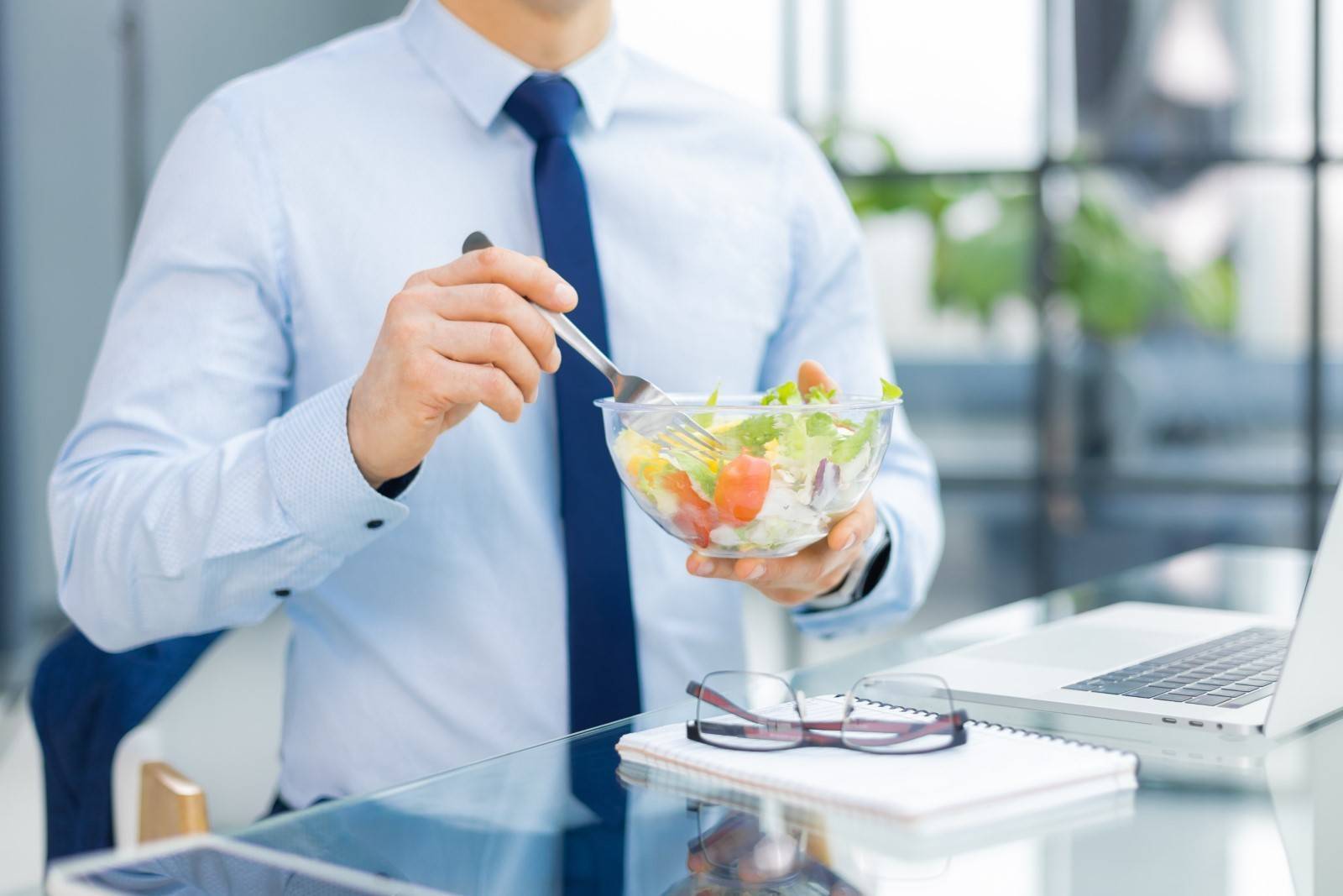 Businessman eating salad