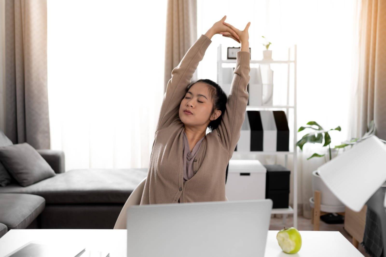 Woman stretching at desk