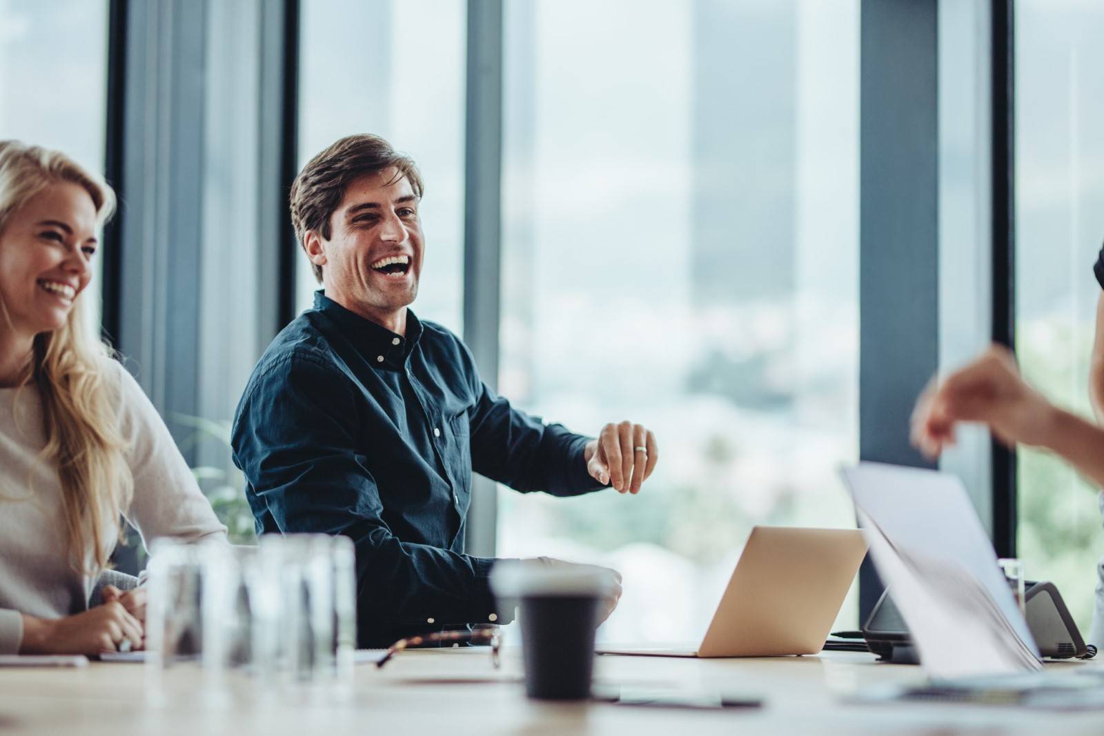 Businesspeople laughing to ease stress