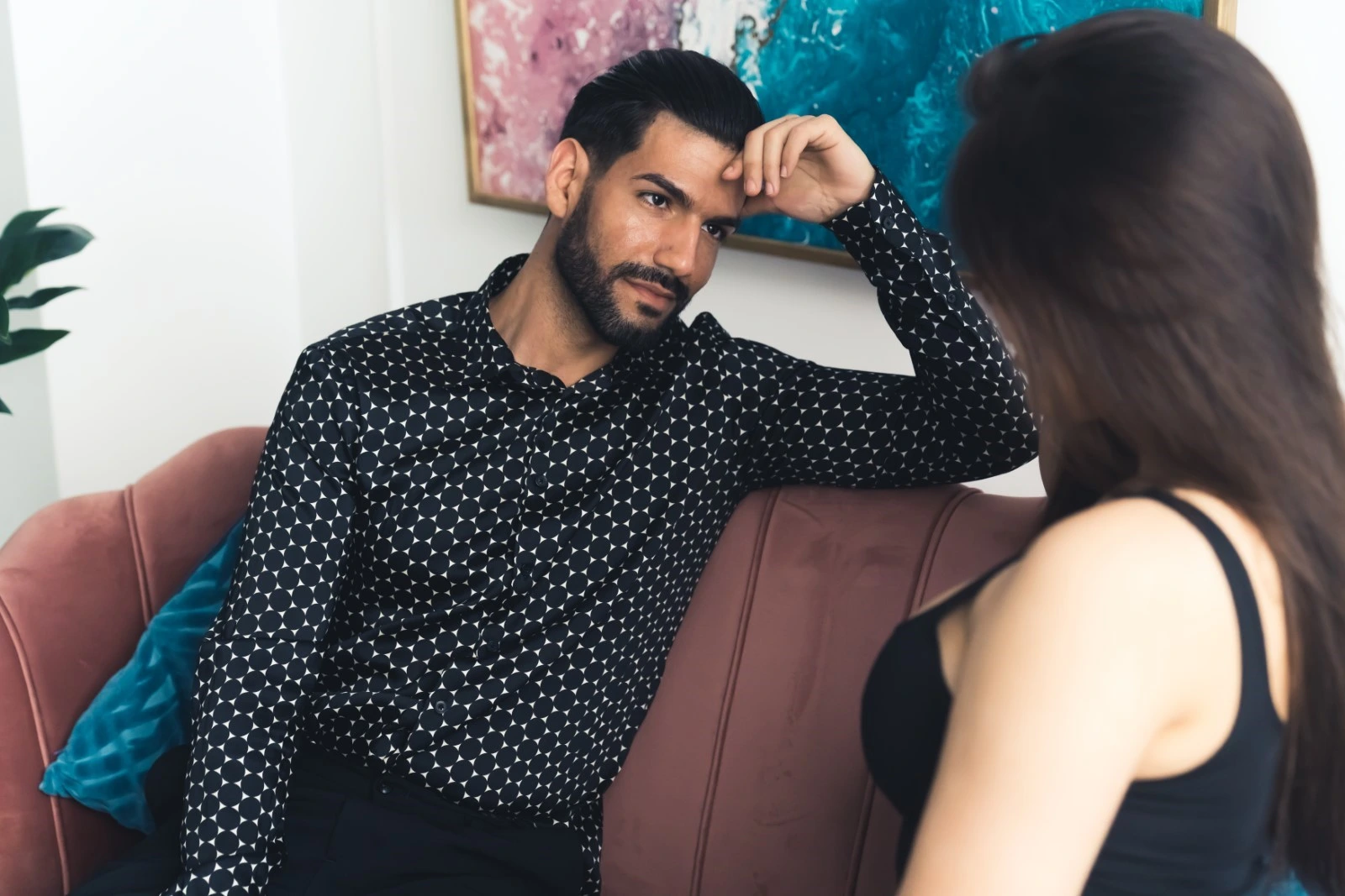 Man and woman talking on couch