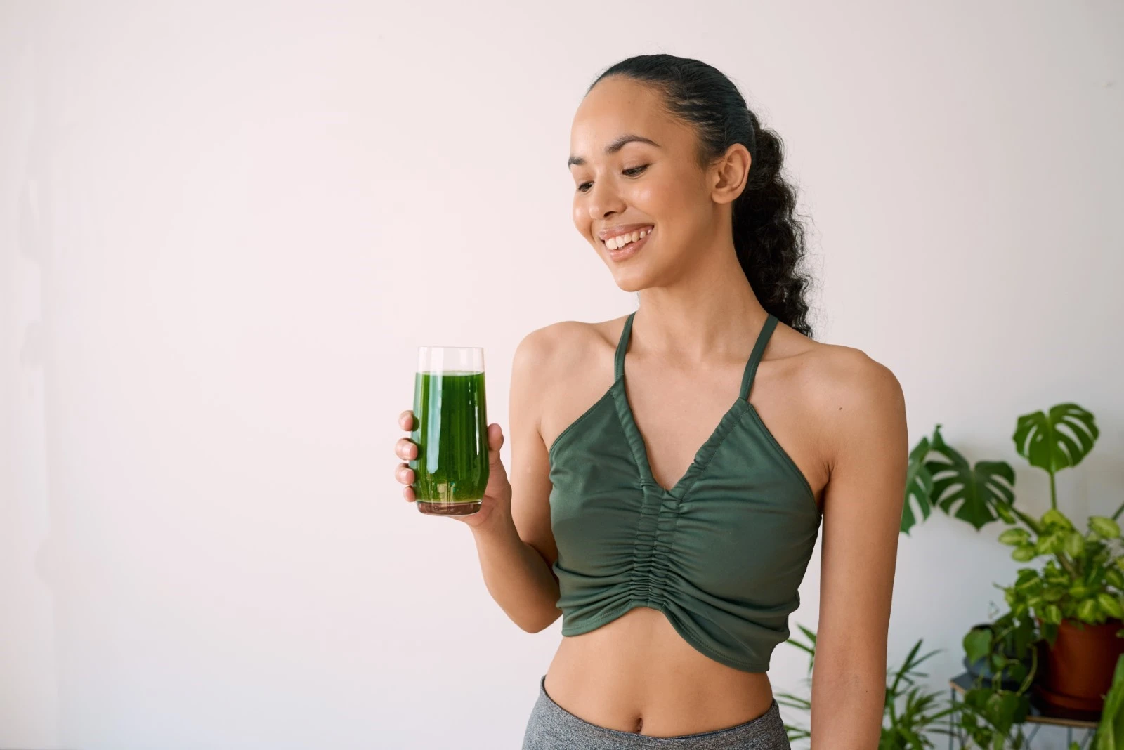Woman drinking green juice